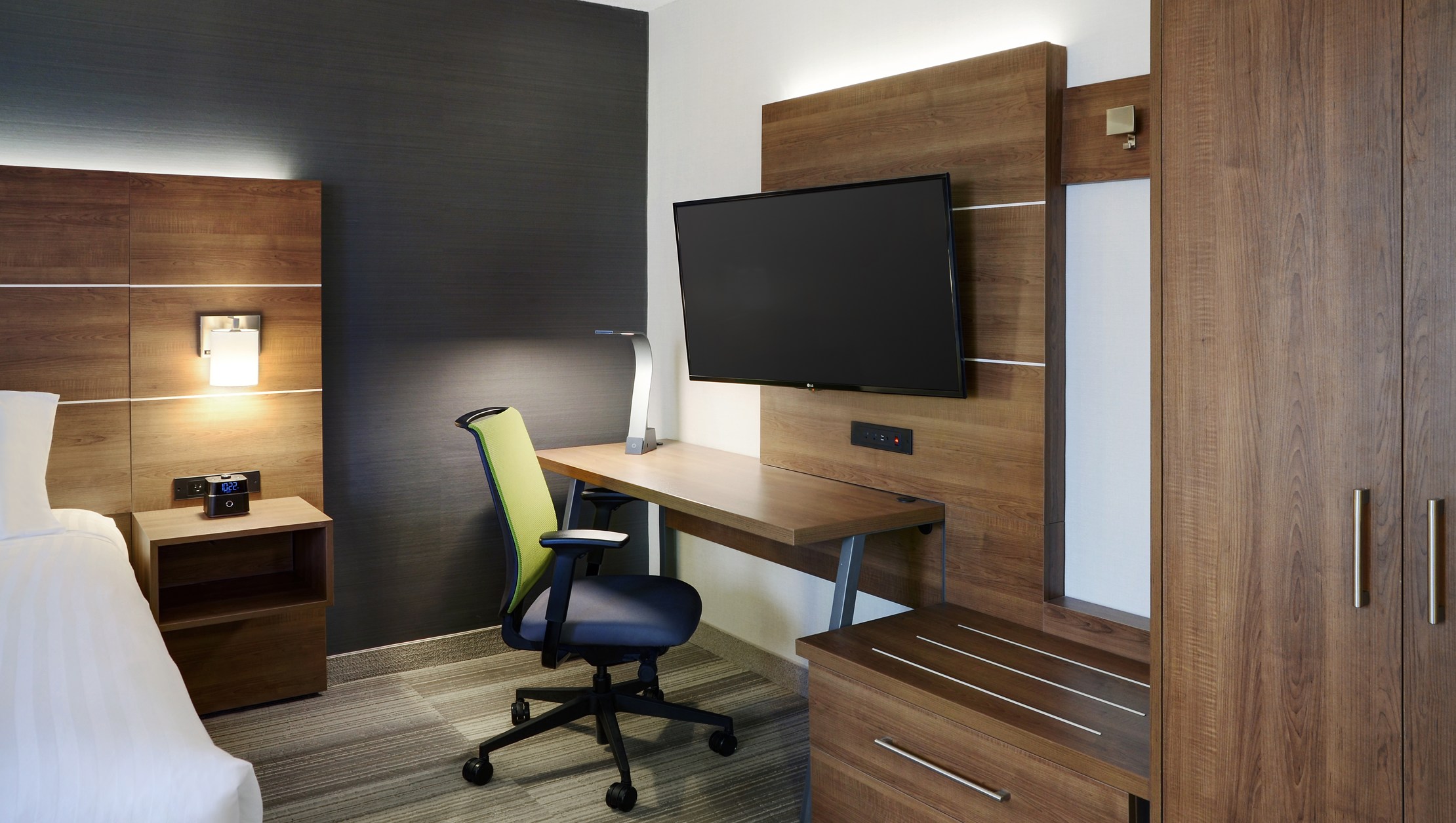Photo of Holiday In Express Toronto Downtown suite with wooden storage, desk and flat screen TV