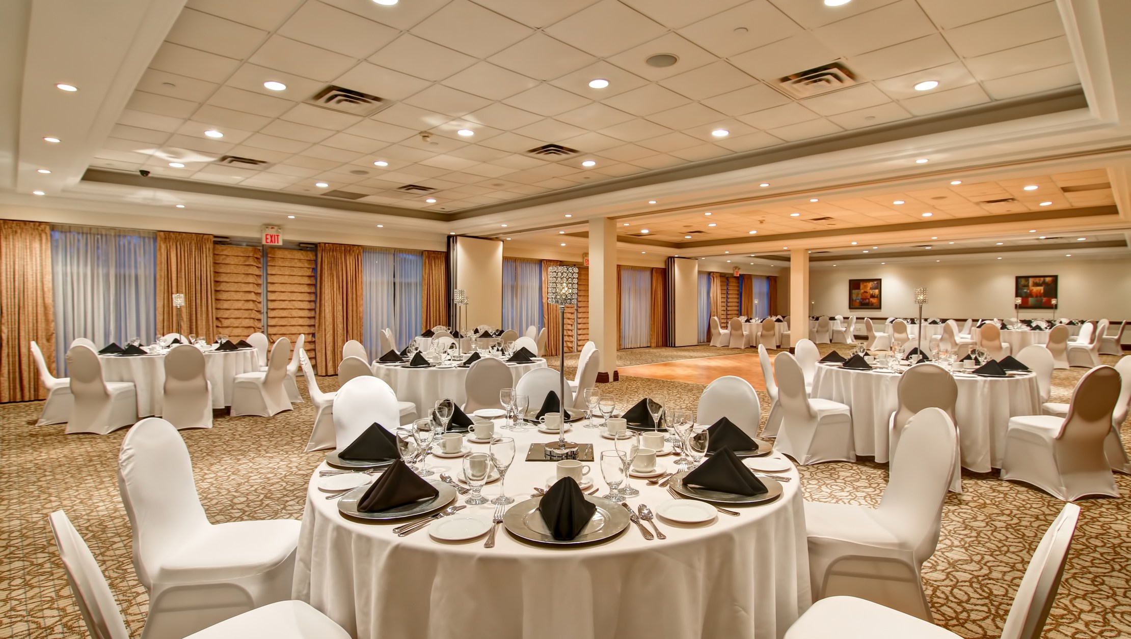 Photo of interior banquet hall with several tables set for event