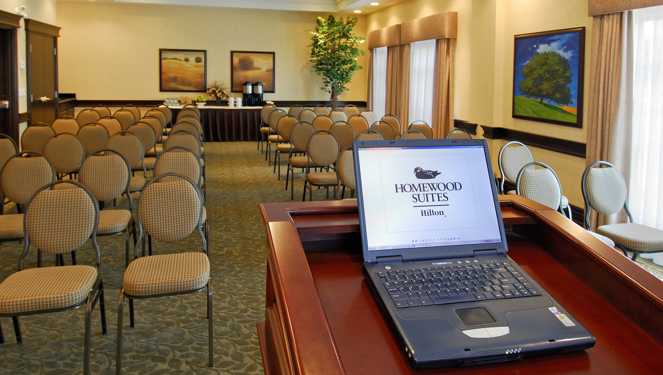 Photo of Homewood Suites by Hilton Burlington Canadian hall with speaker podium and seating area