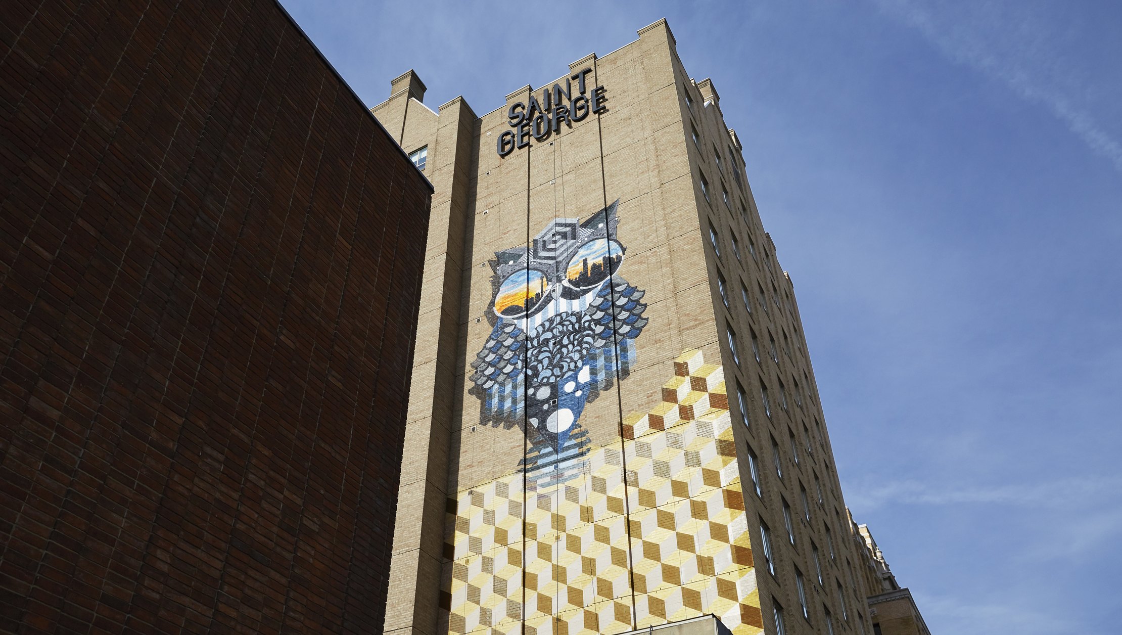 Photo of Kimpton Saint George building exterior with hand painted hour mural on wall
